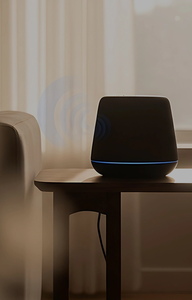 Stylish modern living room interior with dark accent wall, wooden slat panel, cozy armchair, warm ambient lighting, and lush indoor plants by the window.