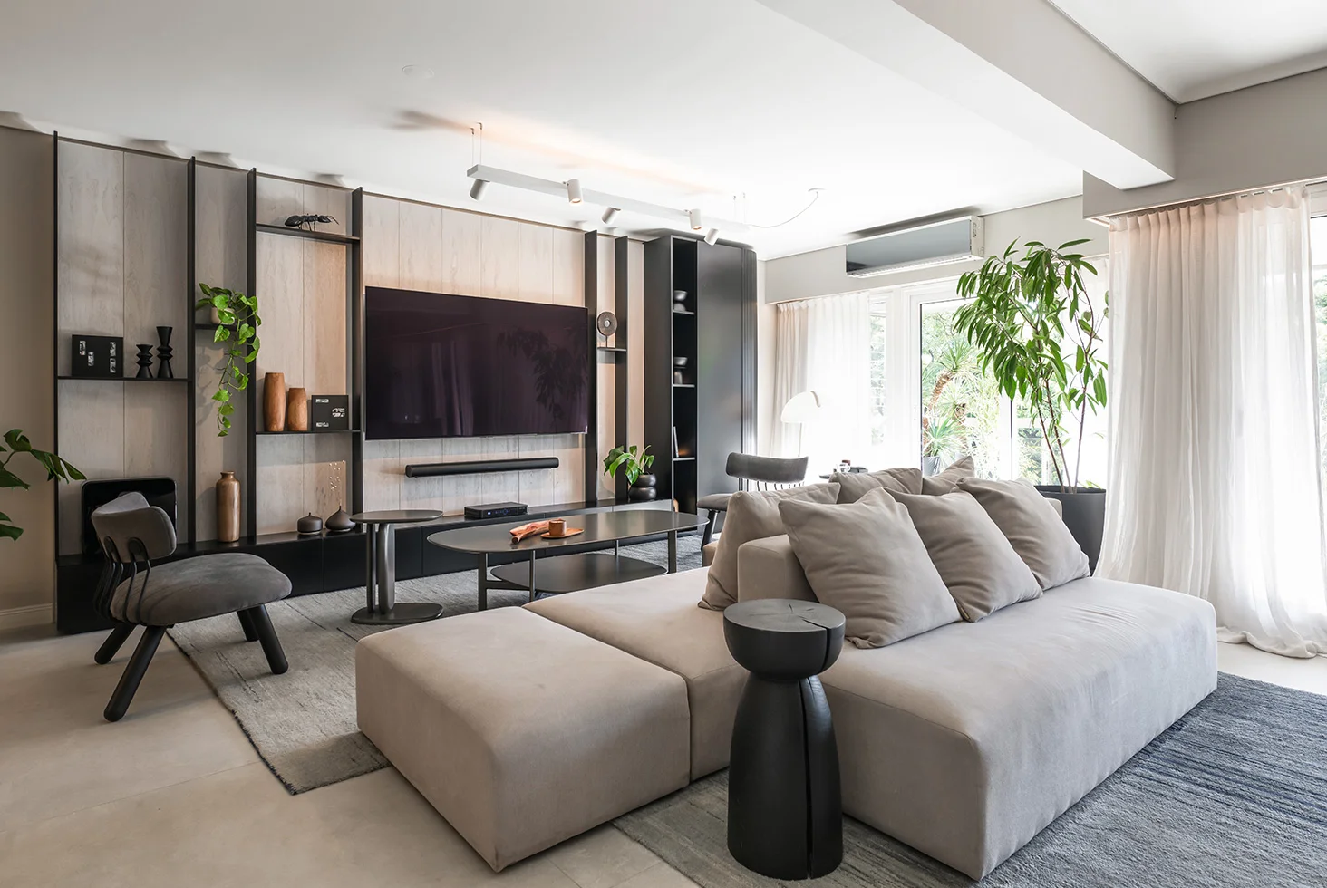 Residential living room at Arenales Apartment with TV wall and sofa.