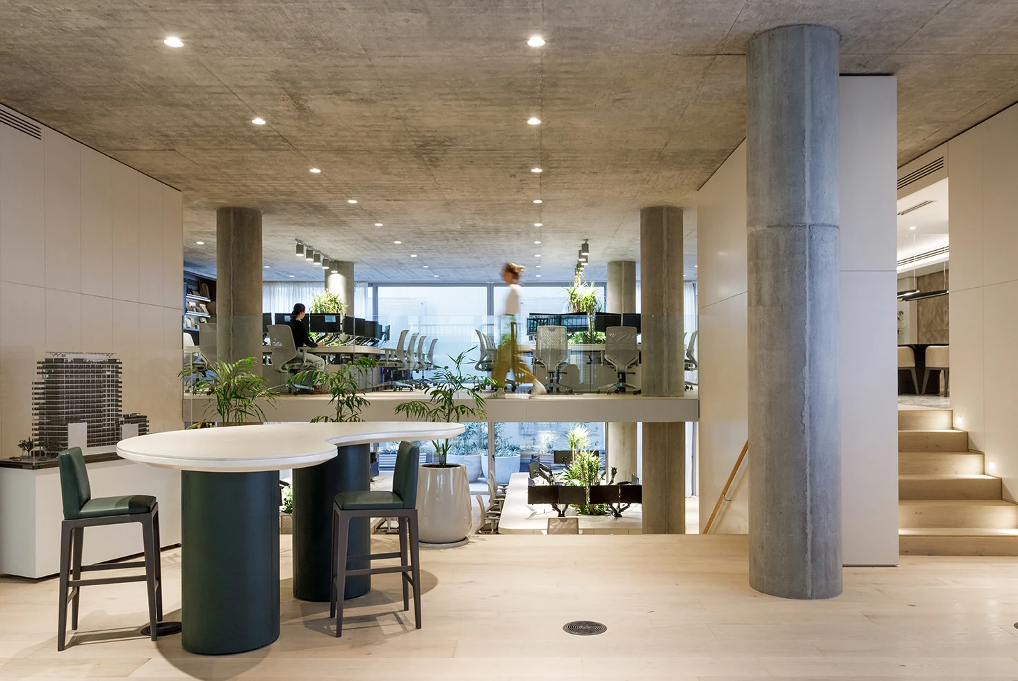 Corporate Azcuy Offices interior featuring open-plan workspace, modern furniture, and natural lighting.