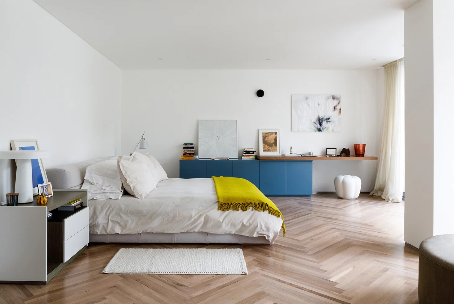 Bedroom at Casa Castex with wooden floor and modern furniture.