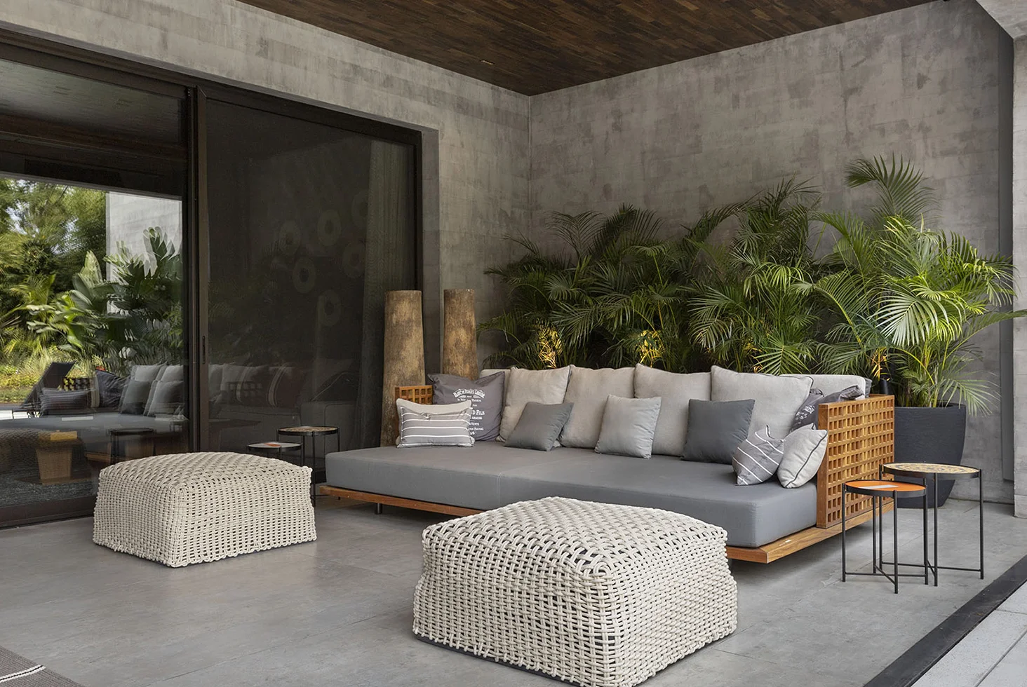 Highland Park residential outdoor lounge with modern sofa and greenery.