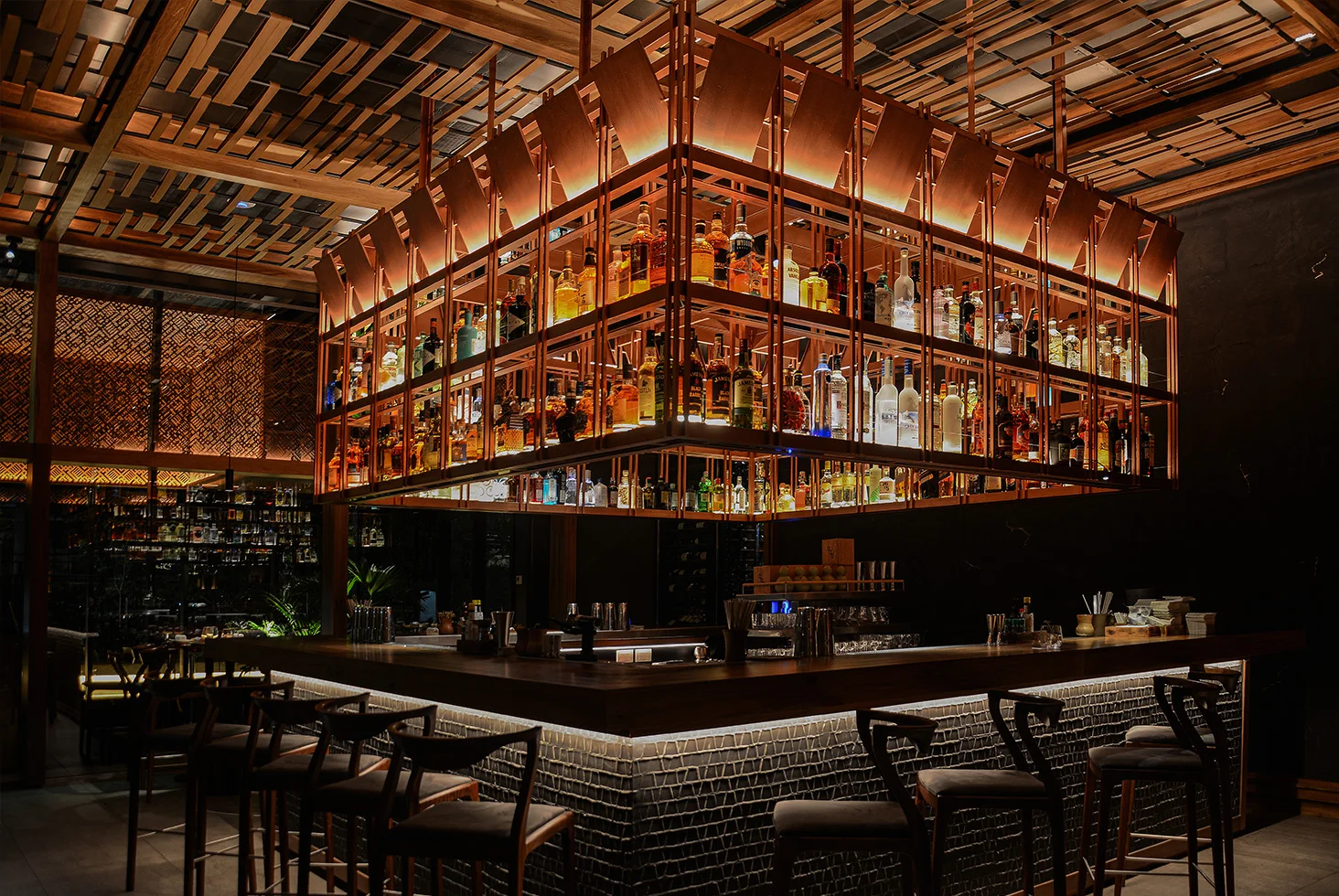 Dining area and sushi bar with warm lighting at Osaka Sushi Rest.